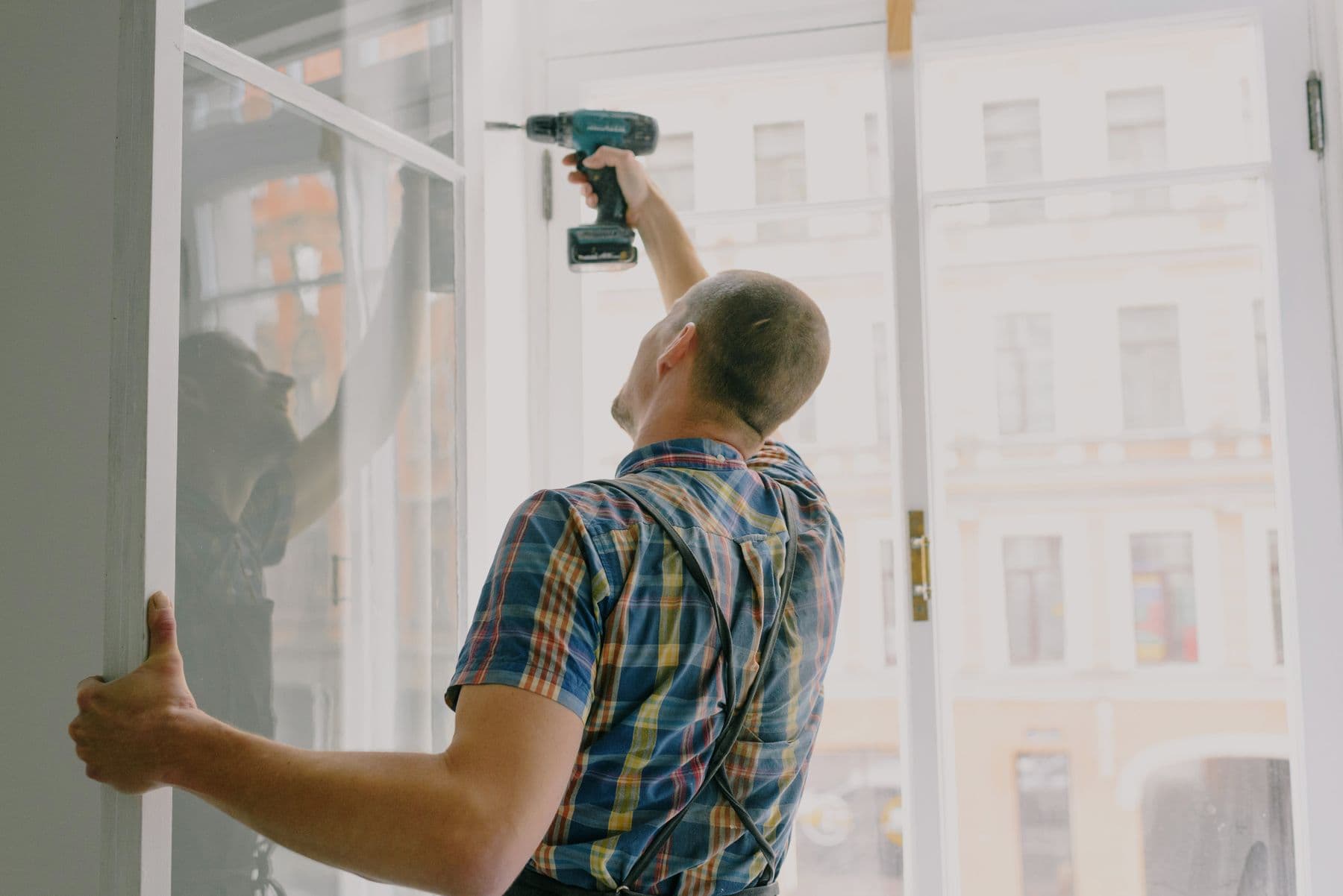 Handyman working with a cordless drill on a home repair job in Gqeberha